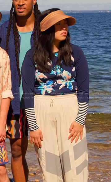 Nora’s blue floral rashguard and visor on Awkwafina is Nora From Queens