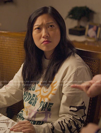Nora’s sun graphic sweatshirt on Awkwafina is Nora From Queens