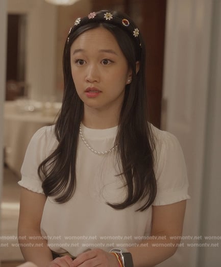 Lily’s white tee and black floral print pants on And Just Like That