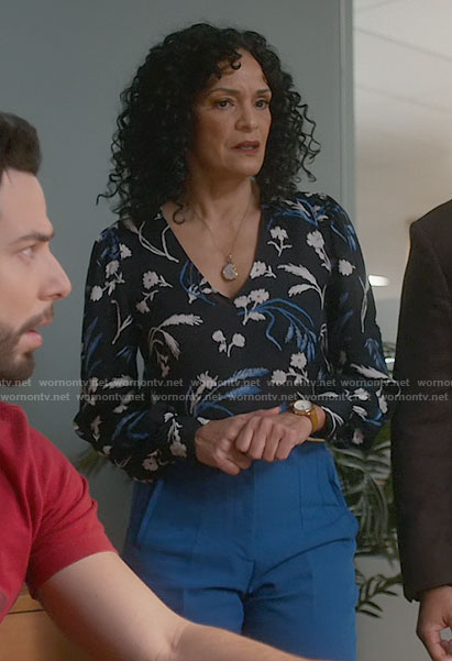Francey’s floral v-neck top and blue pants on So Help Me Todd