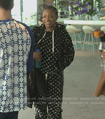 Kandi’s black monogram logo hoodie and pants on The Real Housewives of Atlanta