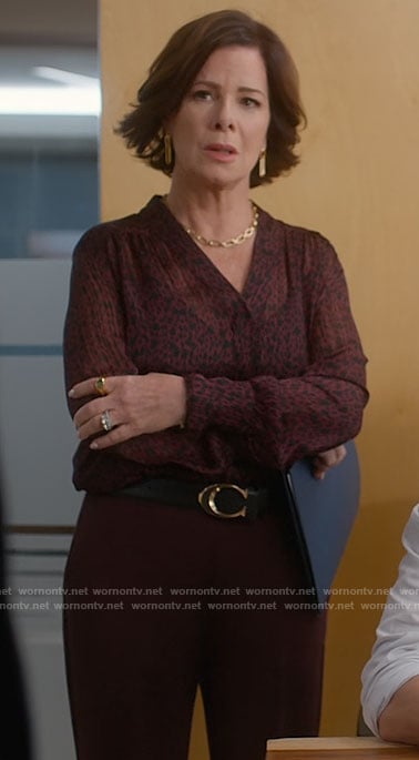 Margaret’s red and black printed v-neck blouse and link earrings on So Help Me Todd