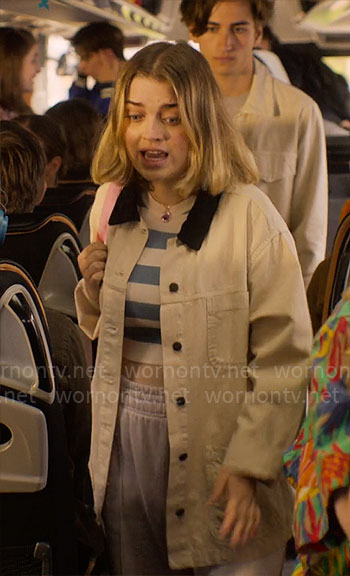 Darcy’s blue striped crop top and cream oversized jacket on Heartstopper