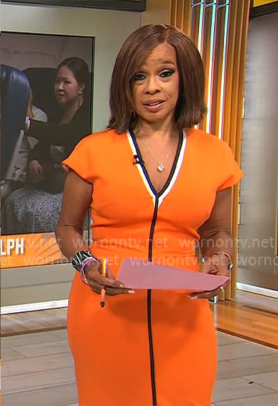 Gayle King’s orange v-neck dress with black trim on CBS This Morning