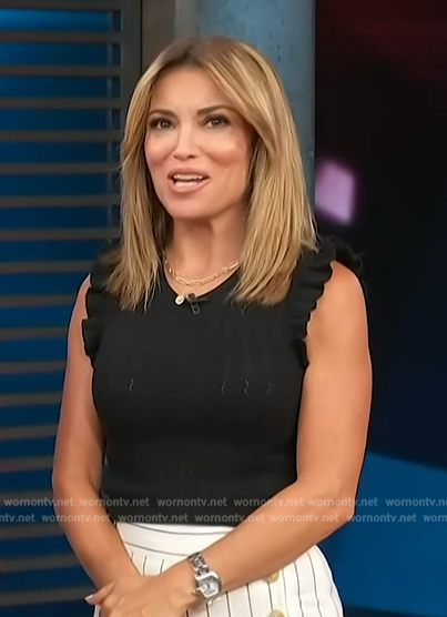 Kit’s black sleeveless knit top and striped pants on Access Hollywood
