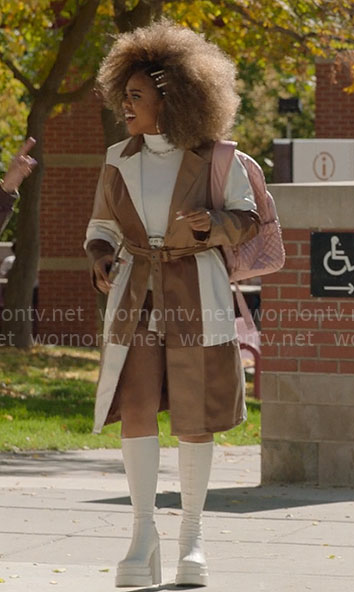 Kourtney’s brown colorblock leather coat and white platform boots on High School Musical The Musical The Series