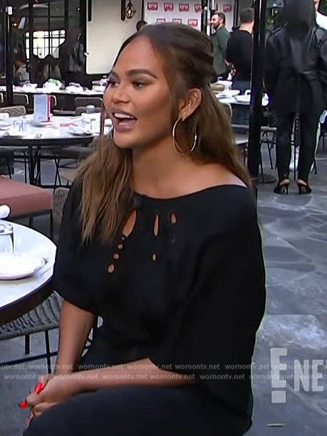 Chrissy Teigan’s black eyelet top on E! News
