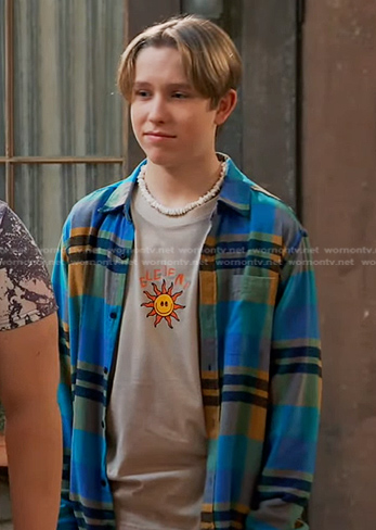 Jake’s beige sun print tee and blue plaid shirt on Bunkd