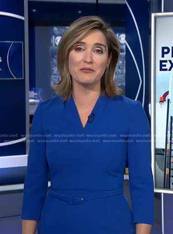 Margaret’s blue v-neck belted dress on CBS Evening News