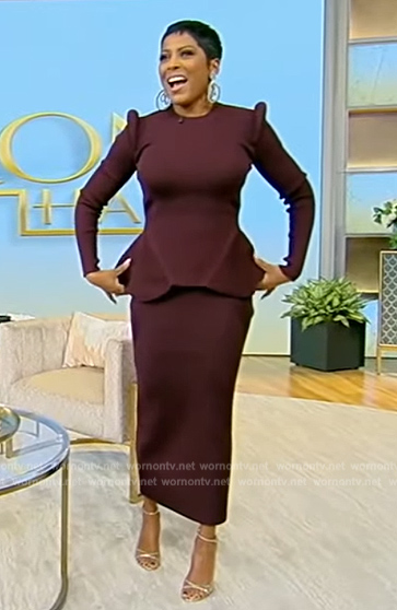 Tamron’s burgundy asymmetrical sweater and skirt on Tamron Hall Show