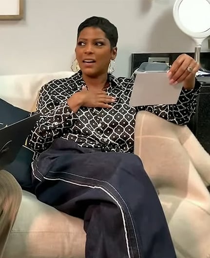 Tamron’s black geometrical print blouse on Tamron Hall Show