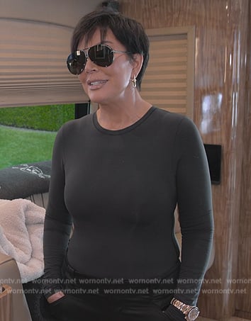 Kris’s black crew neck top and earrings on The Kardashians