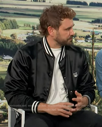 Nick Viall’s black varsity bomber jacket on Access Hollywood