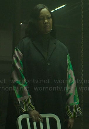 Diana’s black coat with printed sleeves on The Other Black Girl