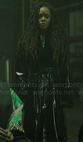 Hazel’s black vinyl coat with fur collar on The Other Black Girl