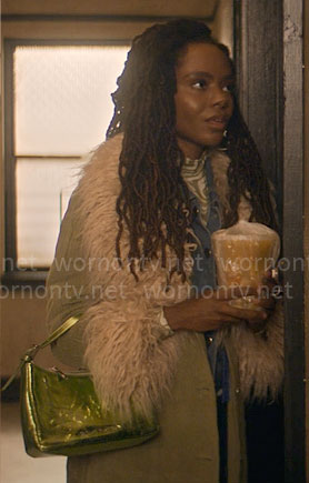 Hazel’s green corduroy coat with fur collar, marble print top and metallic bag on The Other Black Girl