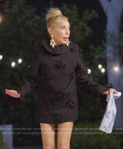 Marysol’s black floral ruffle neck mini dress on The Real Housewives of Miami