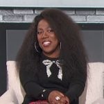 Sheryl’s black bow sweater and plaid pants on The Talk