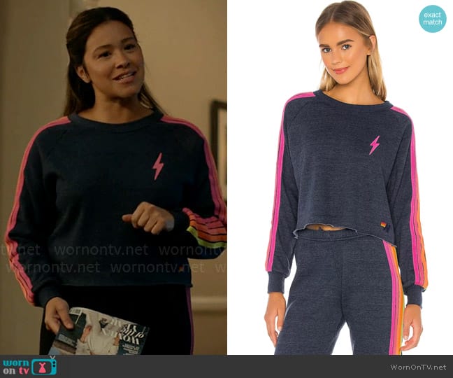 Aviator Nation Bolt Cropped Classic Crewneck in Heather Navy Neon worn by Nell Serrano (Gina Rodriguez) on Not Dead Yet