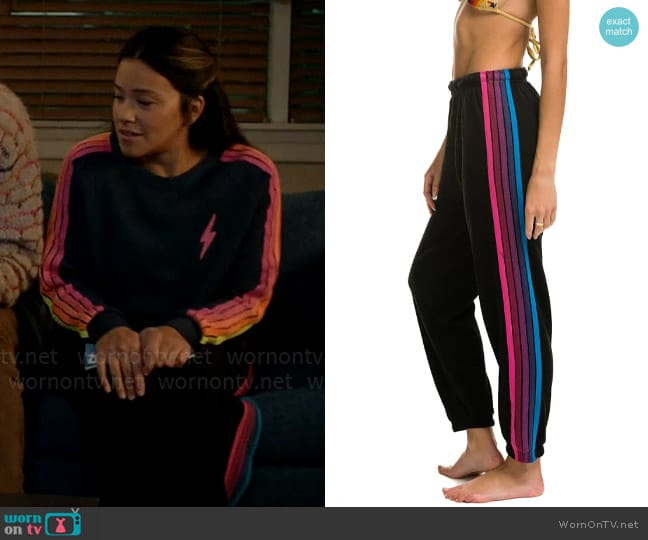 Aviator Nation 5 Stripe Sweatpants in Black Pink Purple worn by Nell Serrano (Gina Rodriguez) on Not Dead Yet