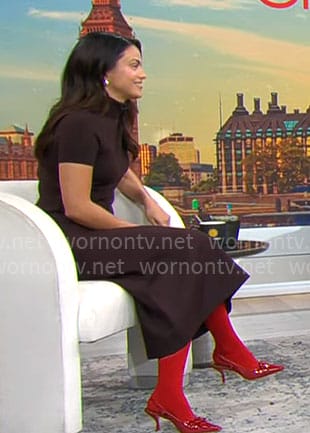 Camila Mendes’ brown turtleneck top and midi skirt with red shoes on CBS Mornings