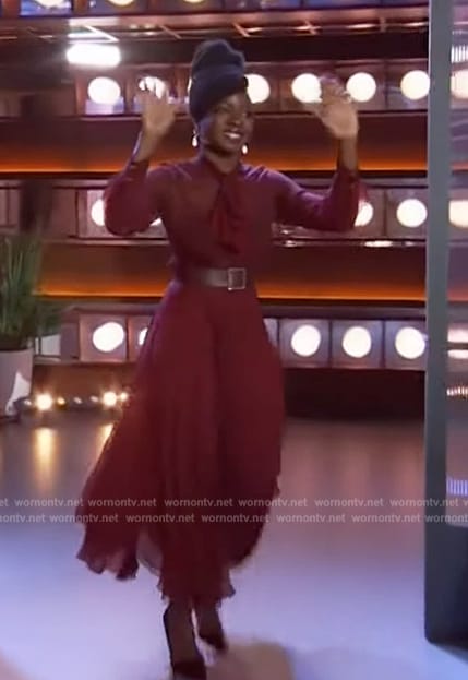 Danai Gurira’s burgundy sheer tie neck dress on The Kelly Clarkson Show