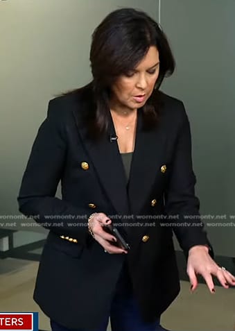 Meg Oliver’s navy blazer with gold buttons on CBS Evening News
