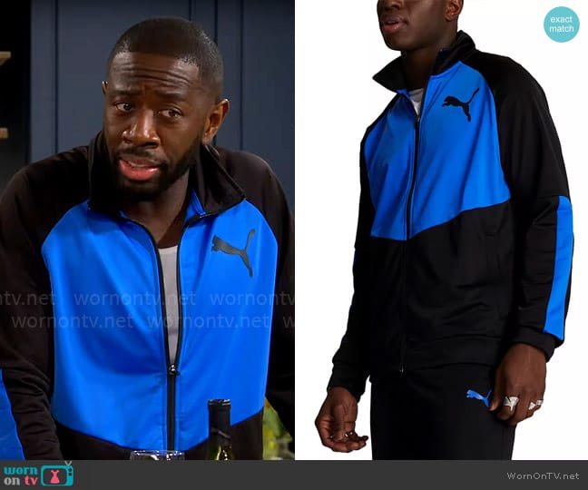 Puma Contrast Logo Tricot Jacket 2.0 in Puma Black Racing Blue worn by Malcom (Sheaun McKinney) on The Neighborhood
