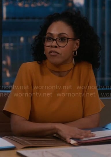 Alex’s yellow mock neck top on So Help Me Todd