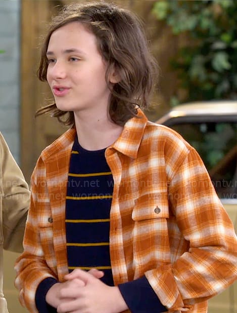 Grover’s striped t-shirt and orange plaid overshirt on The Neighborhood