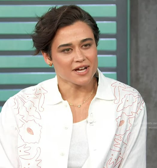 Katy O’Brian’s white floral embroidered shirt and pants on Access Hollywood