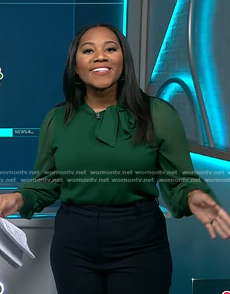 Kay Angrum’s green sheer sleeve tie neck top on NBC News Daily