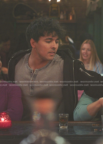 Lucas Adams’s grey henley shirt and black jacket on Greys Anatomy