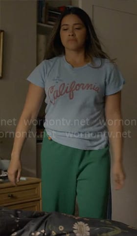 Nell’s blue California tee and green sweatpants on Not Dead Yet