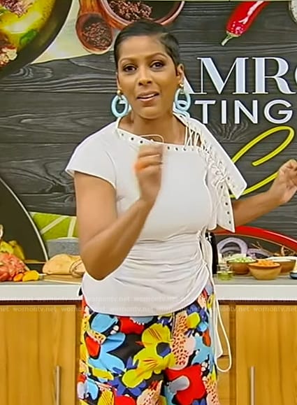 Tamron’s white lace-up top and floral pants on Tamron Hall Show