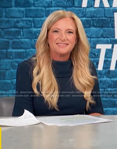 Alison Triessl’s navy folded neck dress on Access Hollywood