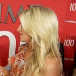 Ashley Bellman’s orange floral ruffle one shoulder dress on E! News