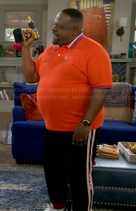 Calvin’s orange striped collar polo shirt on The Neighborhood