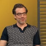 Daniel Ings’s black polo on Access Hollywood