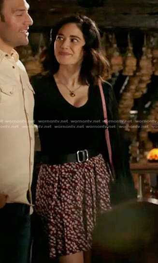 Marisol’s black sheer sleeve top and red print mini skirt on 9-1-1