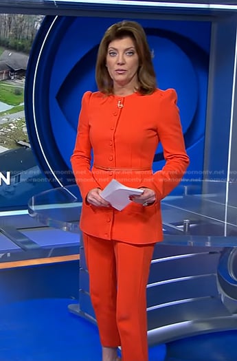 Norah’s orange belted jacket and cropped pants on CBS Evening News