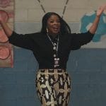 Ava’s black jewel button cardigan and printed pants on Abbott Elementary