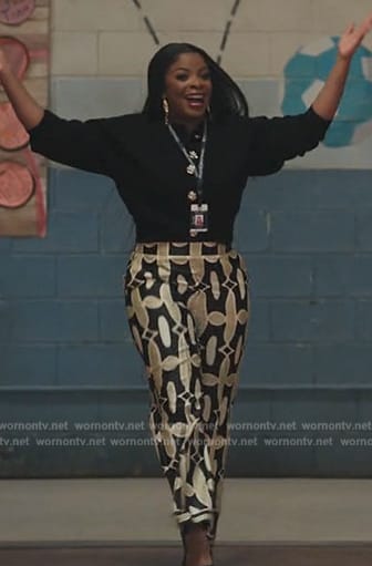 Ava’s black jewel button cardigan and printed pants on Abbott Elementary