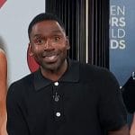 Justin’s black knit polo sweater on E! News