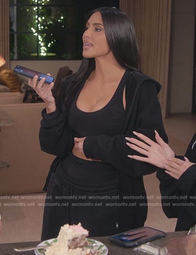 Kim’s black hoodie and sports bra on The Kardashians