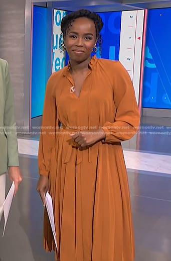 Zinhle’s orange pleated midi dress on NBC News Daily