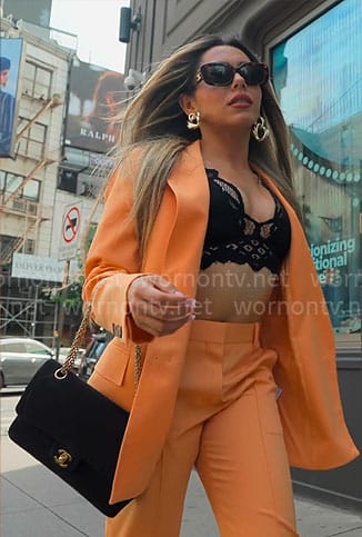 Jade’s orange suit with black lace bra on Owning Manhattan