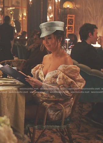 Mindy’s blue floral off-shoulder dress and hat on Emily in Paris