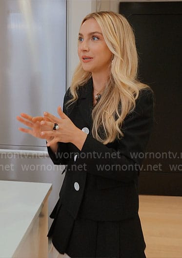Savannah’s black jacket with white buttons, pleated mini skirt and slingbacks on Owning Manhattan