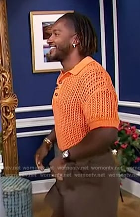 Scott’s orange open knit shirt on Access Hollywood